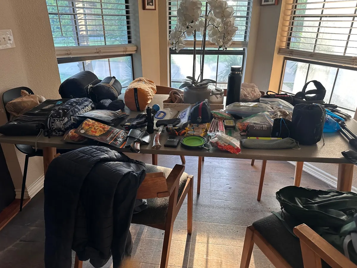 Full gear laid out across the dining table before packing