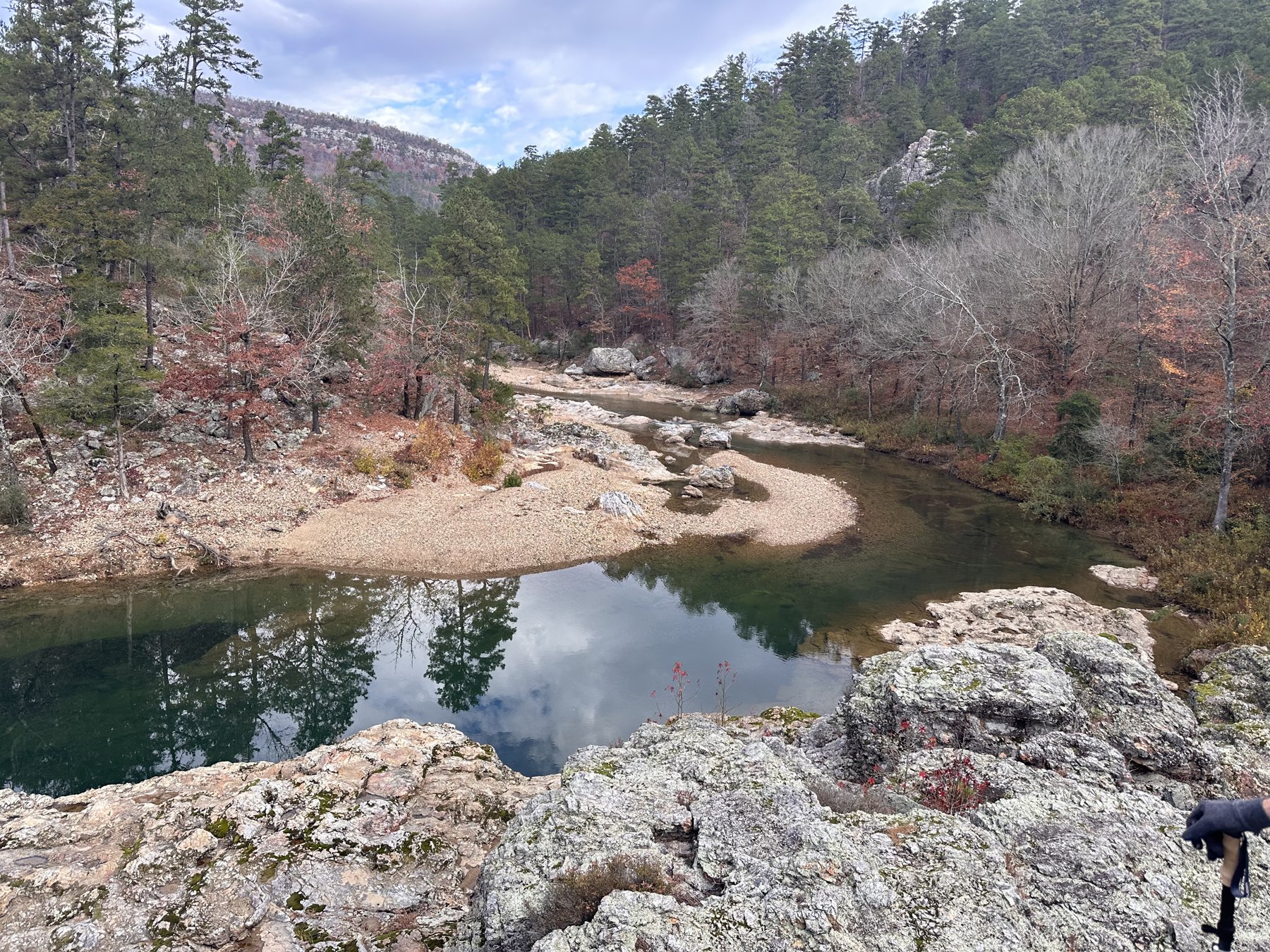 River bend with rocky bank under a blue sky