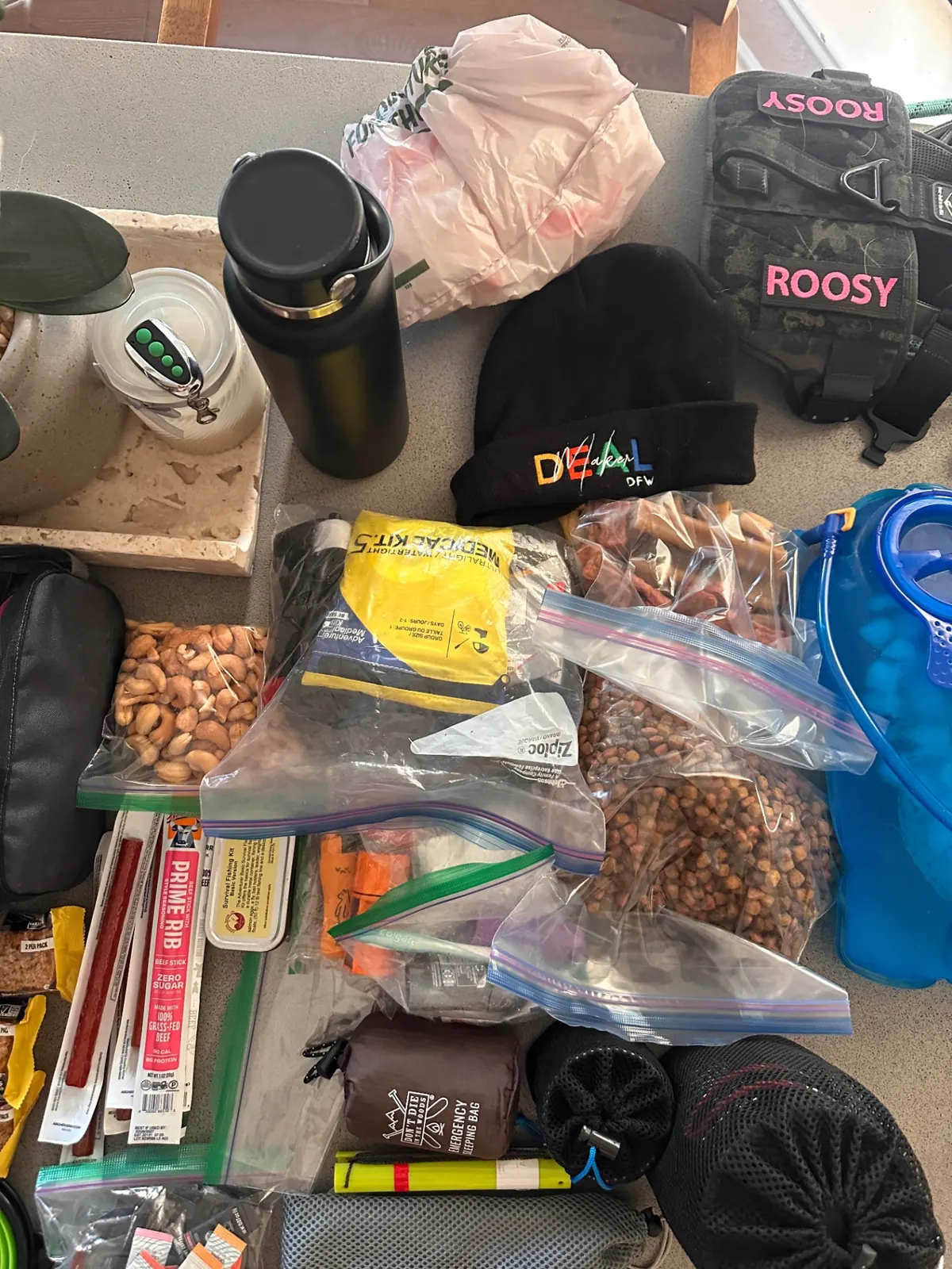 Nuts, jerky, medical kit, fishing kit, and emergency sleeping bag